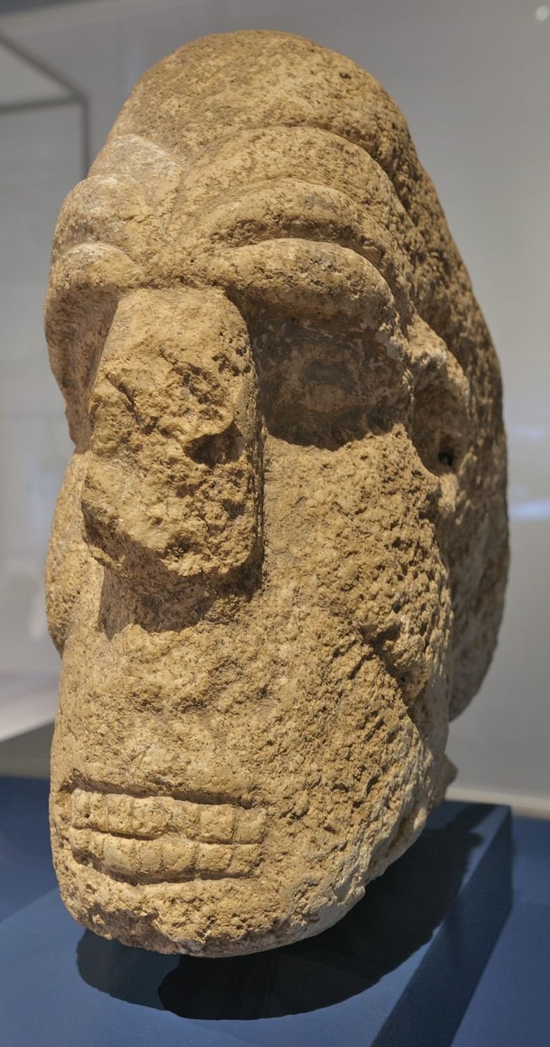 A carved human head from Karahan Tepe, now in the Şanlıurfa museum. At Karahan, detached heads were sculpted and set into the walls to look out over the rooms — the head as architecture.