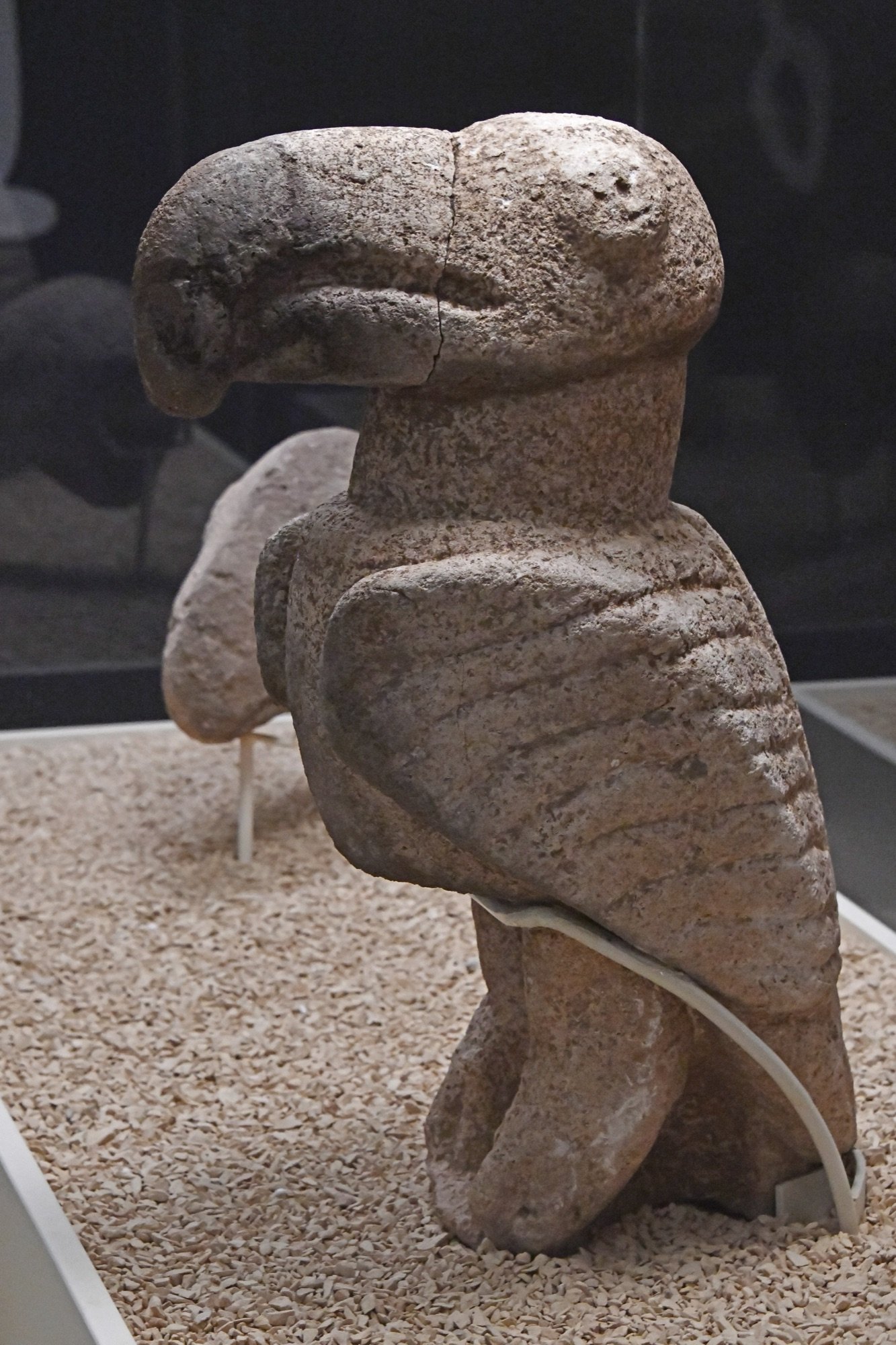 Vulture sculpture from Karahan Tepe — hooked beak, folded wings with incised feathers. Şanlıurfa Archaeology Museum.