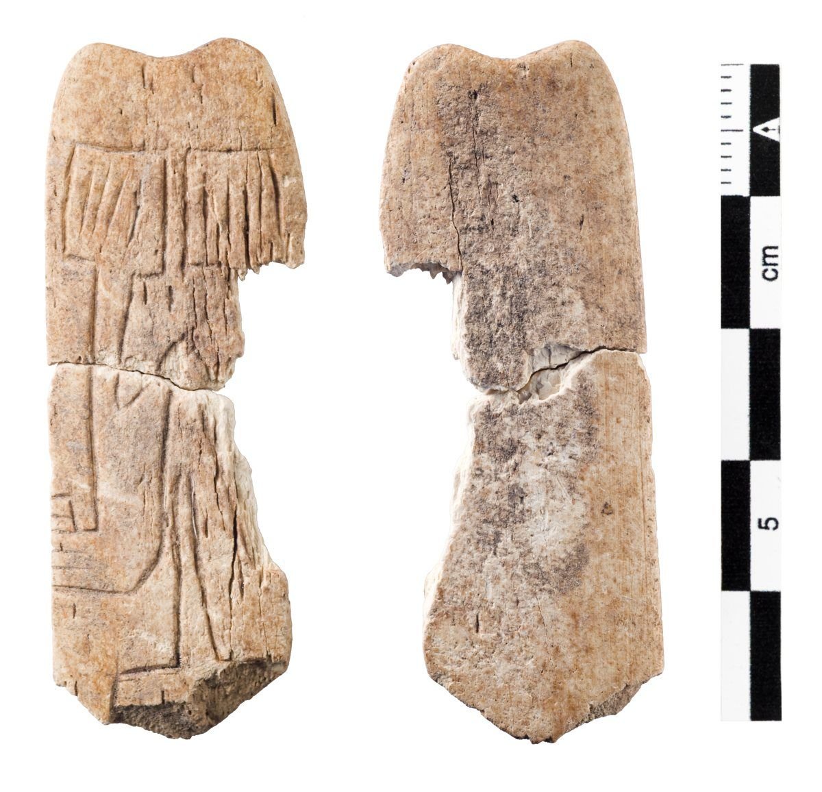 A small decorated bone 'spatula' from Göbekli Tepe, whose worn carving may be an abbreviated two-dimensional depiction of the enclosure's own T-pillars. The reading is tentative.