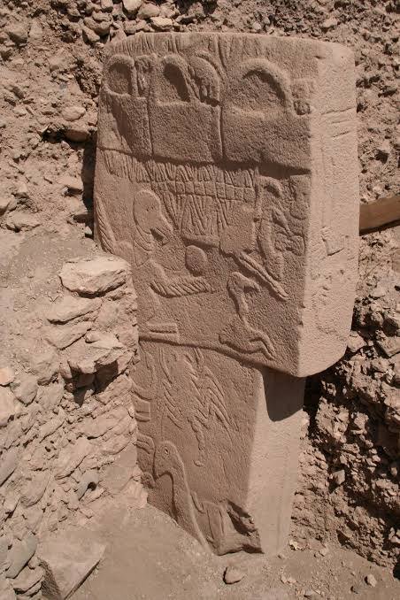 Pillar 43 itself — this is the stone the whole theory is built on. The large vulture with its raised wing and the disc above it, the scorpion lower down, the snakes and birds, and the small headless human figure are all real and undisputed. What they mean is the argument.