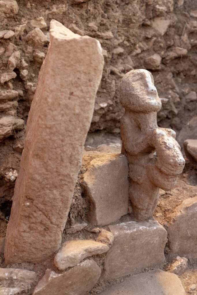 The human-and-leopard sculpture as it was found, resting on the bench of a small circular building at Karahan Tepe in the 2026 season.